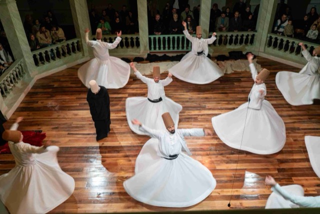 A semazen mid-whirl at Kasımpaşa Mevlevihanesi