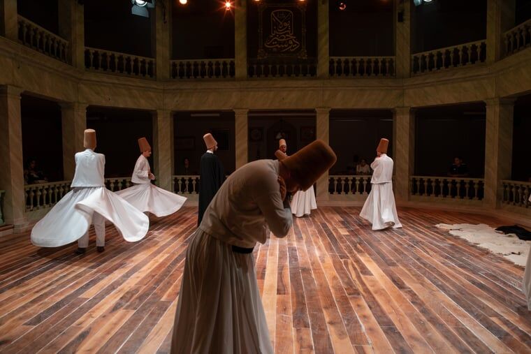 Mevlevi dervishes whirling in white tennure robes during a sema ceremony in Istanbul